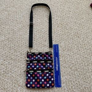 LeSportsac Purple polka dot crossbody with zippers and adjustable straps.
